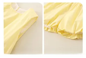 Detail of yellow cotton set showing sleeveless armholes and elasticated ruffled leg openings