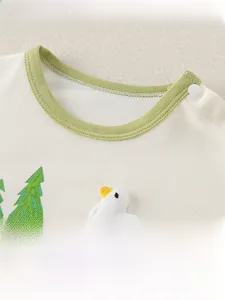 Detailed macro view of waffle cotton baby shirt neckline with snaps and duck embroidery