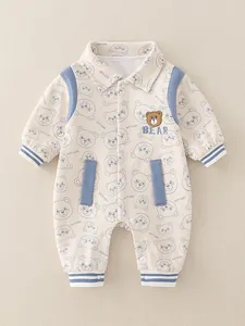 Cotton baby romper with teddy bear prints and blue ribbed cuffs in ivory color