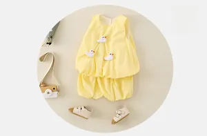 Detail of yellow toddler summer set featuring 3D duck embroidery and bubble shorts