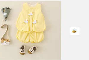 Detail of baby girl summer yellow sleeveless set with 3D ducks and puff shorts