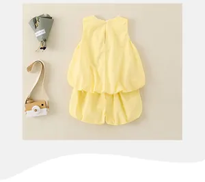 Detailed view of yellow sleeveless cotton set with back button and ruffled hem for girls
