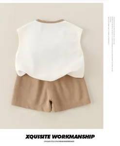 Flat lay of baby boy cotton sleeveless white t-shirt and khaki shorts two-piece set