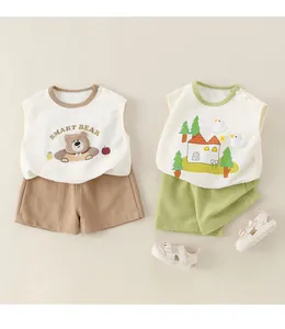 Close-up of cotton baby summer sets with 3D bear and duck appliques on beige background