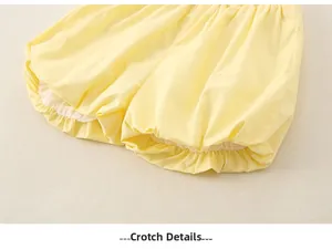 Detailed view of elastic leg openings and crotch stitching on yellow cotton baby bloomers