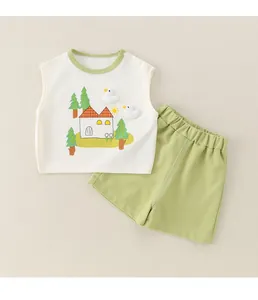 Close-up of cotton baby set with cartoon print, green trim, and 3D bird appliques
