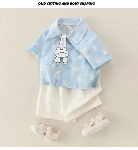 Detail of light blue baby boy summer set with cartoon bear print and matching sandals