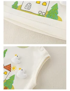 Close-up of cotton baby vest with 3D duck applique and snap button shoulder detail
