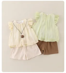 Detail of baby summer sets with pleated flutter sleeves and bear pendant charms