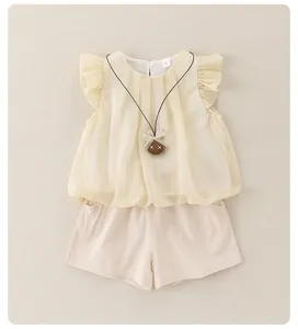 Detail of baby girl summer set featuring ruffled sleeve top and beige drawstring shorts