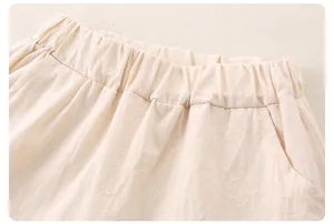 Close-up of elastic waistband on beige cotton-linen blend baby shorts for girls