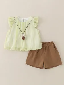 Toddler girl summer set with light green flutter sleeve top and brown elastic shorts