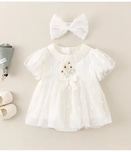 Detailed embroidery on white baby tulle romper with lace headband and sunflower accents