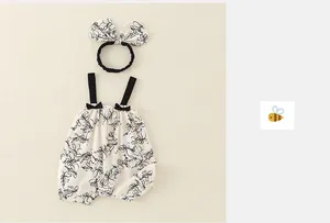 Detail of floral baby romper and bow headband set made from pure organic cotton fabric