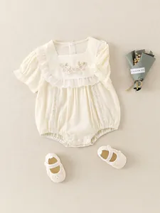 Cute baby girl cream cotton bodysuit with floral embroidery and lace detailing