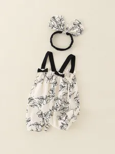 Cute floral cotton baby romper with black straps and matching headband for summer wear