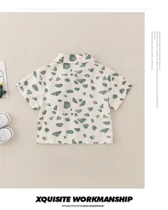 Flat lay of boys cotton short sleeve shirt featuring green stone prints and cactus decor