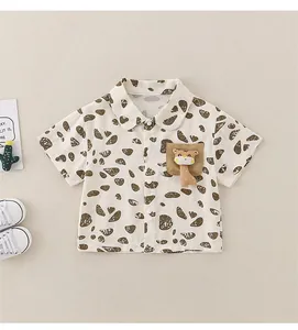 Detail of baby boy cotton shirt with brown pebble print and giraffe pocket