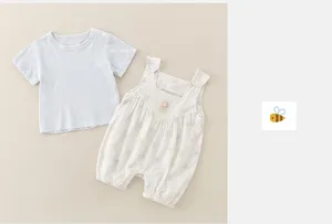 Detail of baby floral romper and blue t-shirt with delicate flower embroidery