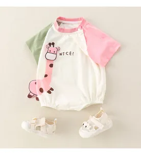 Detail of baby romper with giraffe embroidery and matching white breathable sandals