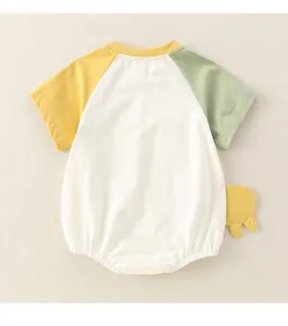 Detail view of cotton baby onesie with contrast raglan sleeves and dinosaur fin accents