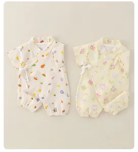 Detail of two summer cotton baby rompers with side-tie closure and cute cartoon patterns