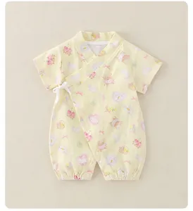 Detail of yellow cotton baby romper featuring cute rabbit prints and side-tie bows
