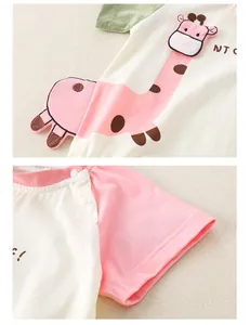 Detail of baby romper with giraffe embroidery and resin shoulder snaps on soft cotton