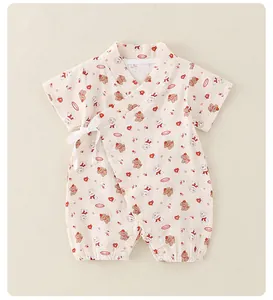 Detail of baby kimono romper with ribbon tie and hidden crotch snaps for easy diapering