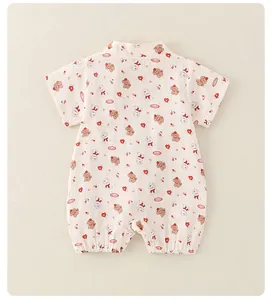 Close-up of thin cotton baby romper featuring cute cartoon dog and heart prints