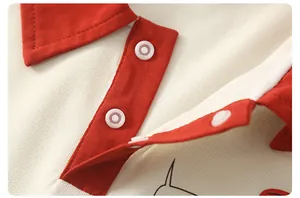 Close-up of red contrast polo collar and snap button detail on breathable cotton shirt