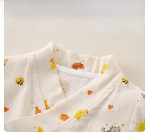 Detail of baby cotton gauze bodysuit showing V-neck design and cute cartoon bee prints