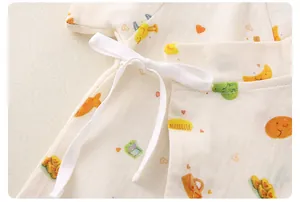 Detail of baby cotton gauze kimono with colorful cartoon prints and side tie closure