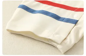 Macro view of breathable cotton mesh fabric with red and blue stripes and snap buttons
