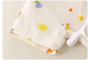 Close-up of thin cotton baby bodysuit with colorful cartoon prints and lace-up neck