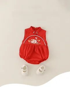 Detail of red Chinese style baby romper with floral embroidery and pearl buttons