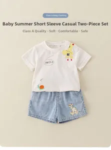 Detail showing cartoon giraffe embroidery on blue denim baby shorts for summer