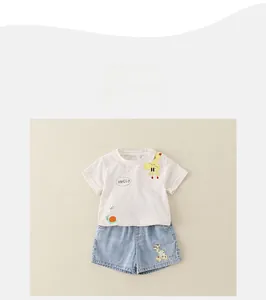 Flat lay of cotton summer outfit with cartoon deer print and denim shorts for toddlers