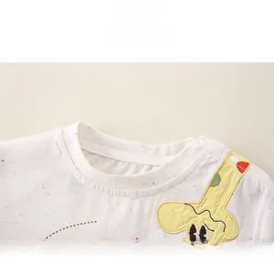 Detail view of baby shirt round neckline with side snap button and cartoon giraffe applique