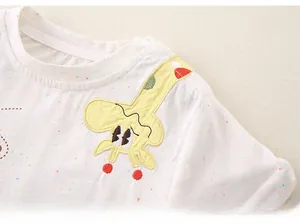 Detail of baby t-shirt featuring giraffe applique, shoulder snaps, and colorful speckle fabric