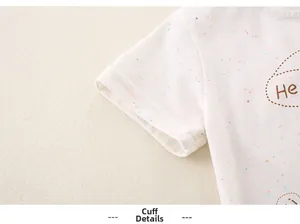 Detail of white cotton toddler T-shirt sleeve with color flecks and flat stitching