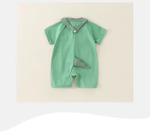 Detail of baby summer romper featuring cute 3D dinosaur tail and V-neck snap back design
