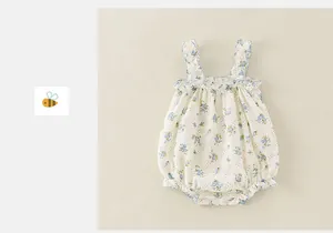 Detail of floral baby bodysuit with ruffle straps and snap buttons for summer
