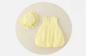 Detail of baby summer sleeveless cotton bubble dress and matching ruffled sun hat in yellow