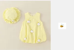 Close-up of baby yellow sun dress with cute 3D duck appliques and matching ruffle hat