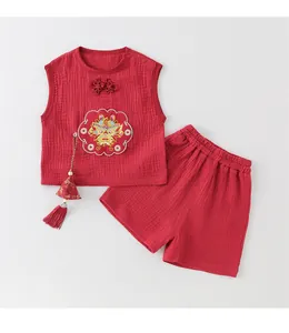 Detail of red cotton baby suit featuring traditional dragon embroidery and Chinese knots