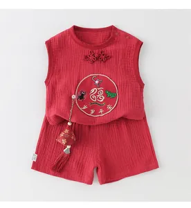 Detail of baby cotton festive set with traditional Chinese embroidery and tassel charms