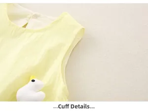 Macro shot of cotton baby dress cuff detail with a cute 3D plush duck decoration