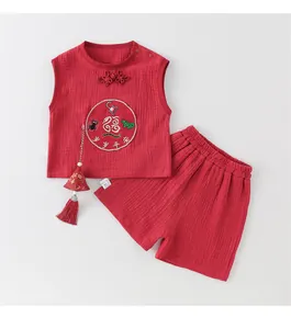 Detail of traditional Chinese cotton baby set with embroidered longevity patterns and tassels