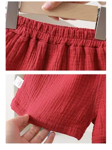Detail of red baby cotton pants with elastic waistband and high-quality 100% cotton fabric